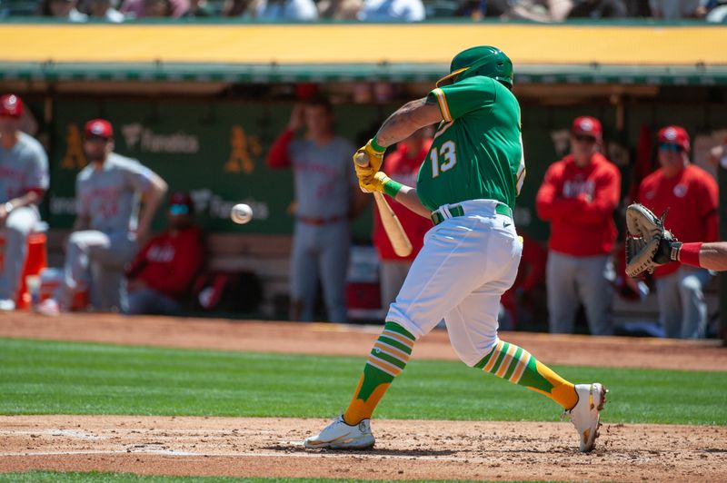 Apr 29, 2023; Oakland, California, USA; Oakland Athletics second baseman Jordan Diaz (13) hits an rbi single during the second inning against the Cincinnati Reds at RingCentral Coliseum. Mandatory Credit: Ed Szczepanski-USA TODAY Sports