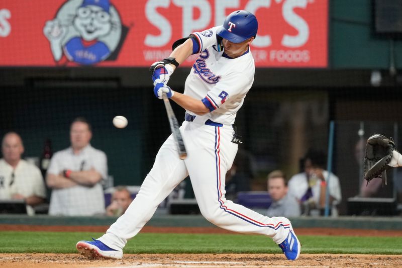 May 29, 2024; Arlington, Texas, USA;  Texas Rangers shortstop Corey Seager (5) connects for a two-run home run against the Arizona Diamondbacks during the fifth inning at Globe Life Field. Mandatory Credit: Jim Cowsert-USA TODAY Sports