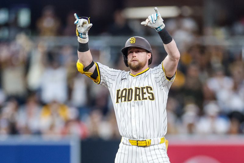 Jun 24, 2025; San Diego, California, USA; San Diego Padres second baseman Jake Cronenworth (9) celebrates with the dugout after hitting an RBI double during the fourth inning against the Washington Nationals at Petco Park. Mandatory Credit: David Frerker-Imagn Images
