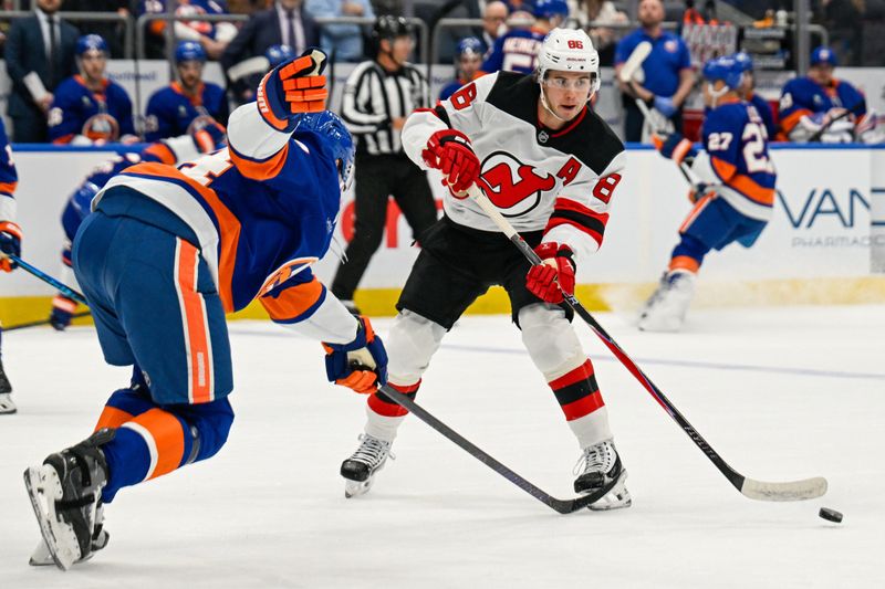Jan 6, 2026; Elmont, New York, USA; New Jersey Devils center Jack Hughes (86) attempts a pass defended by New York Islanders center Jean-Gabriel Pageau (44) during the first period at UBS Arena. Mandatory Credit: Dennis Schneidler-Imagn Images