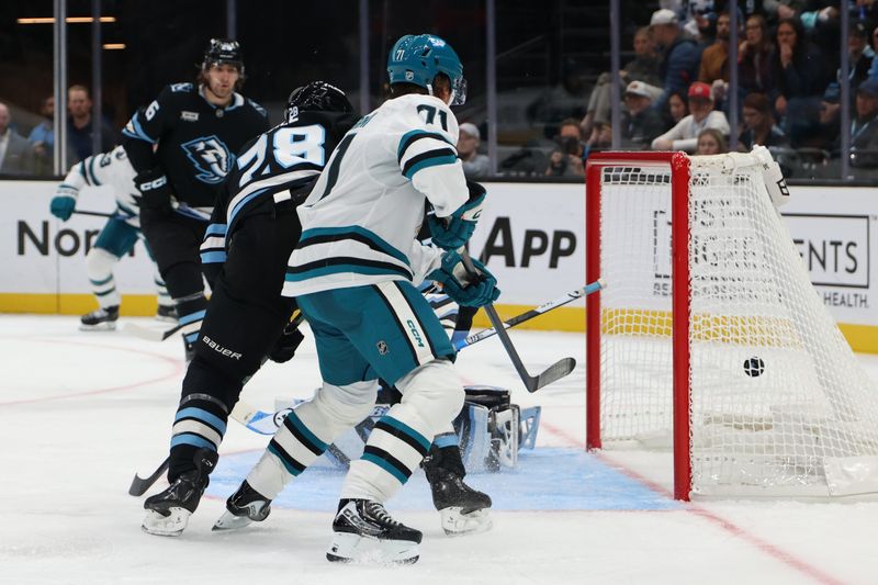 Oct 17, 2025; Salt Lake City, Utah, USA; San Jose Sharks center Macklin Celebrini (71) assist a goal against the Utah Mammoth during the second period at Delta Center. Mandatory Credit: Rob Gray-Imagn Images