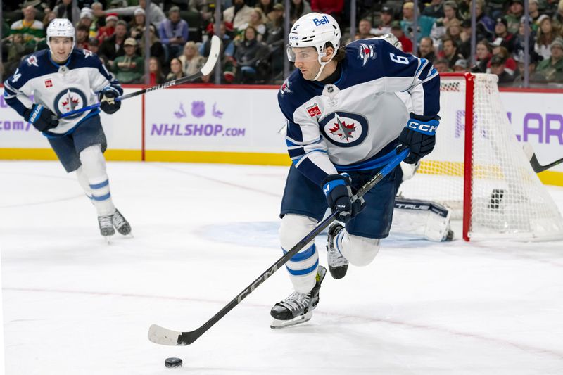 Nov 25, 2024; Saint Paul, Minnesota, USA;  Winnipeg Jets defenseman Colin Miller (6) controls the puck against the Minnesota Wild during the second period at Xcel Energy Center. Mandatory Credit: Nick Wosika-Imagn Images