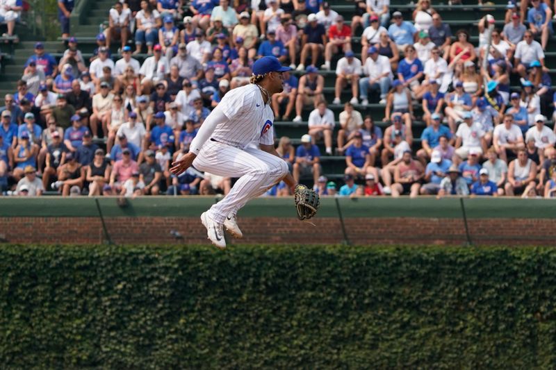 Jul 16, 2023; Chicago, Illinois, USA; Chicago Cubs second baseman Christopher Morel (5) is unable to make a play on a single hit by Boston Red Sox center fielder Rob Refsnyder (30) during the eighth inning at Wrigley Field. Mandatory Credit: David Banks-USA TODAY Sports