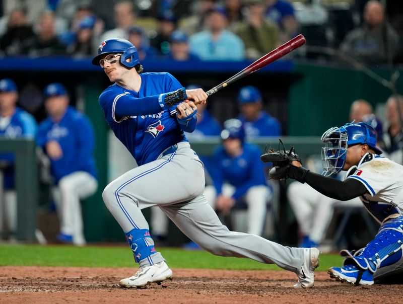 Apr 22, 2024; Kansas City, Missouri, USA; Toronto Blue Jays catcher Danny Jansen (9) hits a double against the Kansas City Royals during the ninth inning at Kauffman Stadium. Mandatory Credit: Jay Biggerstaff-USA TODAY Sports