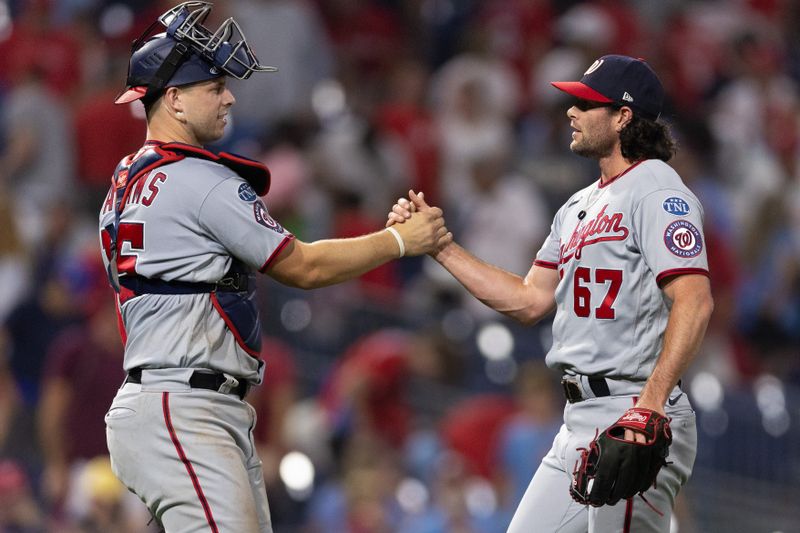 Aug 8, 2023; Philadelphia, Pennsylvania, USA; Washington Nationals relief pitcher Kyle Finnegan (67) and catcher Riley Adams (15) shake hands after a victory against the Philadelphia Phillies at Citizens Bank Park. Mandatory Credit: Bill Streicher-USA TODAY Sports