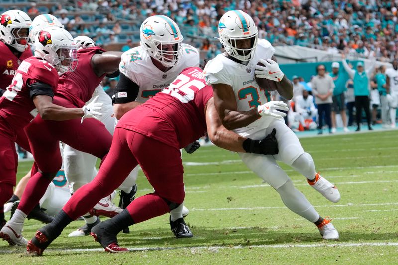 Miami Dolphins running back Raheem Mostert (31) scores a touchdown during the first half of an NFL football game against the Arizona Cardinals, Sunday, Oct. 27, 2024, in Miami Gardens, Fla. (AP Photo/Lynne Sladky)