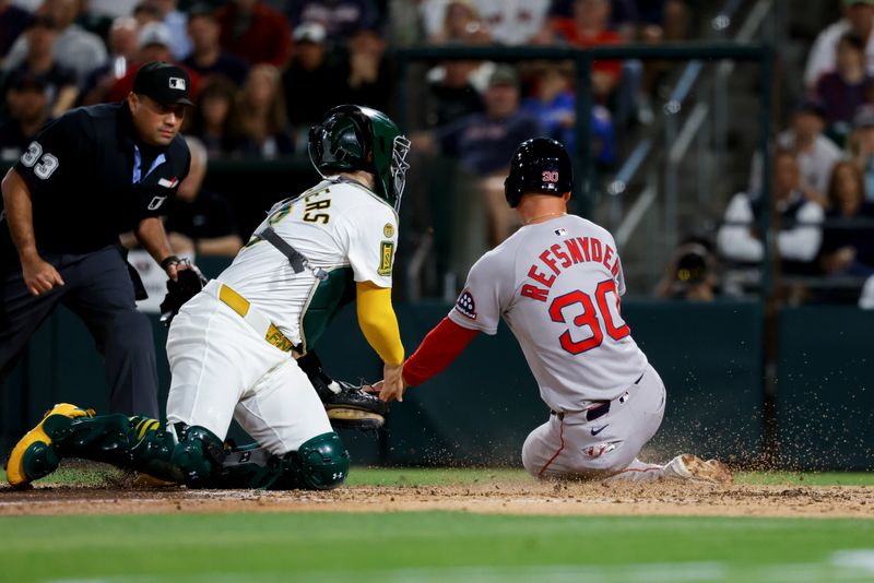 Sep 9, 2025; West Sacramento, California, USA; Boston Red Sox designated hitter Rob Refsnyder (30) is tagged out at home plate by Athletics catcher Shea Langeliers (23) during the sixth inning at Sutter Health Park. Mandatory Credit: Sergio Estrada-Imagn Images