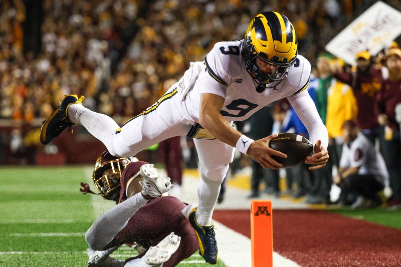 Oct 7, 2023; Minneapolis, Minnesota, USA; Michigan Wolverines quarterback J.J. McCarthy (9) dives for a  touchdown against the Minnesota Golden Gophers during the second quarter at Huntington Bank Stadium. Mandatory Credit: Matt Krohn-USA TODAY Sports