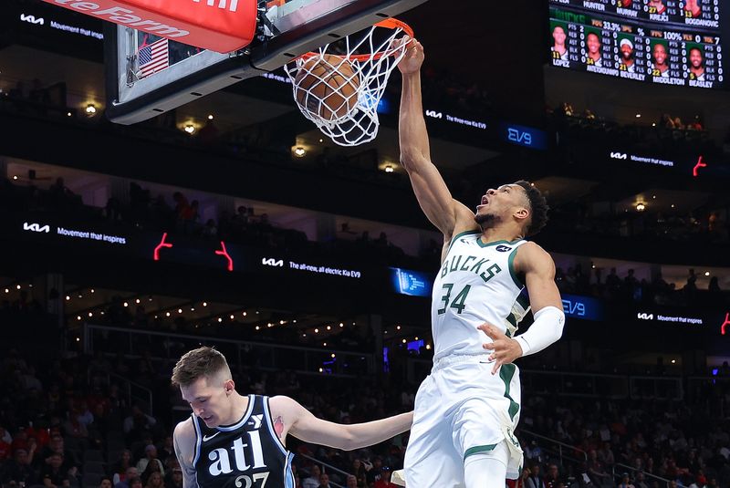ATLANTA, GEORGIA - MARCH 30:  Giannis Antetokounmpo #34 of the Milwaukee Bucks dunks against Vit Krejci #27 of the Atlanta Hawks during the first quarter at State Farm Arena on March 30, 2024 in Atlanta, Georgia.  NOTE TO USER: User expressly acknowledges and agrees that, by downloading and/or using this photograph, user is consenting to the terms and conditions of the Getty Images License Agreement.  (Photo by Kevin C. Cox/Getty Images)