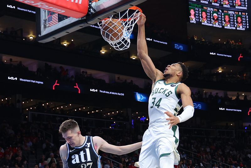 ATLANTA, GEORGIA - MARCH 30:  Giannis Antetokounmpo #34 of the Milwaukee Bucks dunks against Vit Krejci #27 of the Atlanta Hawks during the first quarter at State Farm Arena on March 30, 2024 in Atlanta, Georgia.  NOTE TO USER: User expressly acknowledges and agrees that, by downloading and/or using this photograph, user is consenting to the terms and conditions of the Getty Images License Agreement.  (Photo by Kevin C. Cox/Getty Images)