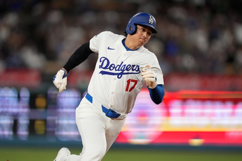 Aug 21, 2024; Los Angeles, California, USA; Los Angeles Dodgers designated hitter Shohei Ohtani (17) rounds third base to score in the third inning against the Seattle Mariners at Dodger Stadium. Mandatory Credit: Kirby Lee-USA TODAY Sports