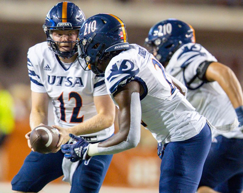 Sep 17, 2022; Austin, Texas, USA; UTSA Roadrunners quarterback Eddie Lee Marburger (12) hands the ball off to running back Tye Edwards (22) against the Texas Longhorns during the fourth quarter at Darrell K Royal-Texas Memorial Stadium. Mandatory Credit: John Gutierrez-USA TODAY Sports