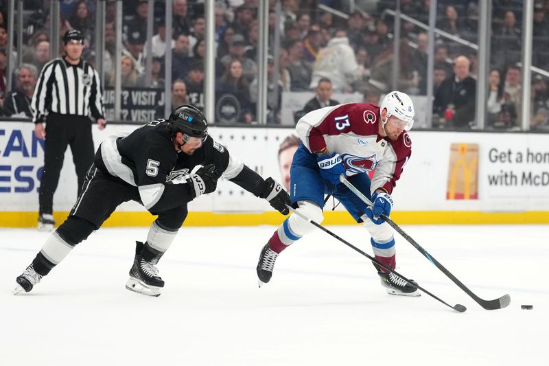 Mar 2, 2026; Los Angeles, California, USA; Colorado Avalanche right wing Valeri Nichushkin (13) and LA Kings defenseman Cody Ceci (5) battle for the puck in the first period at Crypto.com Arena. Mandatory Credit: Kirby Lee-Imagn Images