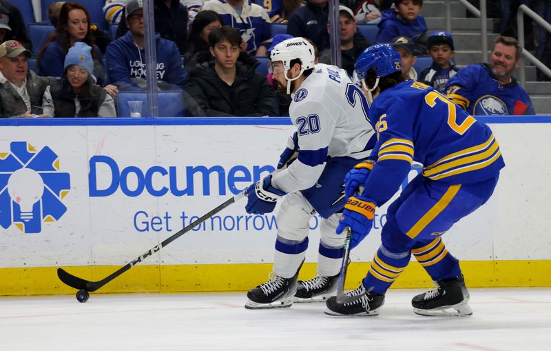 Jan 20, 2024; Buffalo, New York, USA;  Tampa Bay Lightning left wing Nicholas Paul (20) carries the puck up ice as Buffalo Sabres defenseman Owen Power (25) defends during the third period at KeyBank Center. Mandatory Credit: Timothy T. Ludwig-USA TODAY Sports