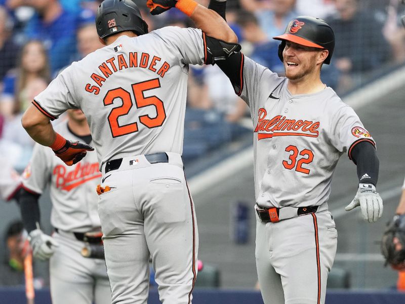 Jun 3, 2024; Toronto, Ontario, CAN; Baltimore Orioles right fielder Anthony Santander (25) hits a two run home run and celebrates with designated hitter Ryan O'Hearn (32) against the Toronto Blue Jays during the second inning at Rogers Centre. Mandatory Credit: Nick Turchiaro-USA TODAY Sports