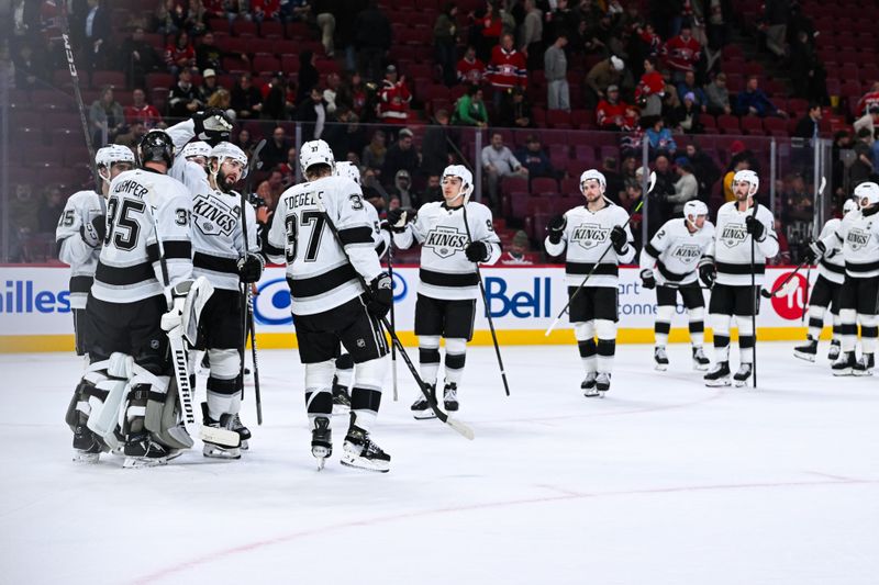 Nov 11, 2025; Montreal, Quebec, CAN; Los Angeles Kings players gather around goalie Darcy Kuemper (35) to celebrate their win against the Montreal Canadiens after the third period at Bell Centre. Mandatory Credit: David Kirouac-Imagn Images