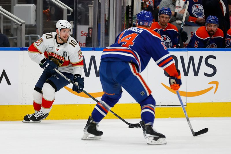 Jun 15, 2024; Edmonton, Alberta, CAN; Florida Panthers right wing Vladimir Tarasenko (10) skates with the puck defense by Edmonton Oilers defenseman Mattias Ekholm (14) in the first period in game four of the 2024 Stanley Cup Final at Rogers Place. Mandatory Credit: Perry Nelson-USA TODAY Sports