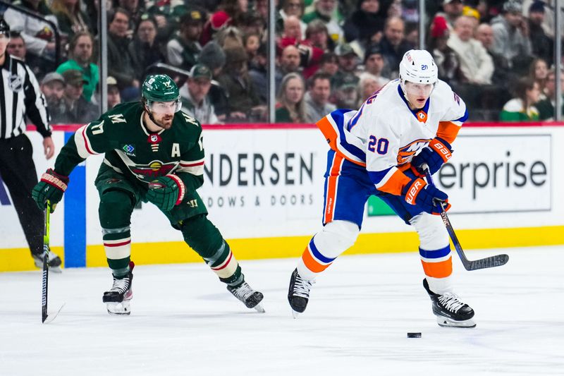 Jan 15, 2024; Saint Paul, Minnesota, USA; New York Islanders right wing Hudson Fasching (20) carries the puck past Minnesota Wild left wing Marcus Foligno (17) during the first period at Xcel Energy Center. Mandatory Credit: Brace Hemmelgarn-USA TODAY Sports