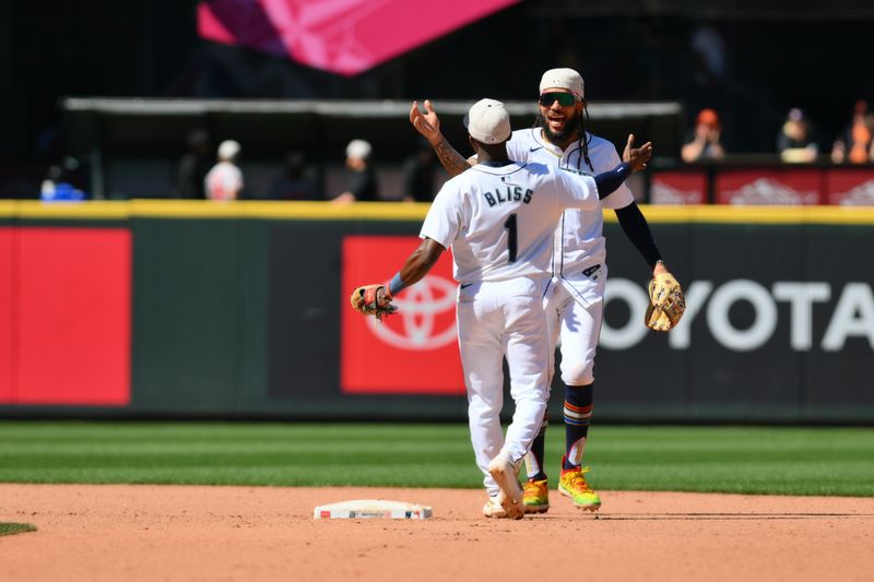 Jul 4, 2024; Seattle, Washington, USA; Seattle Mariners second baseman Ryan Bliss (1) and shortstop J.P. Crawford (3) celebrate defeating the Baltimore Orioles at T-Mobile Park. Mandatory Credit: Steven Bisig-USA TODAY Sports