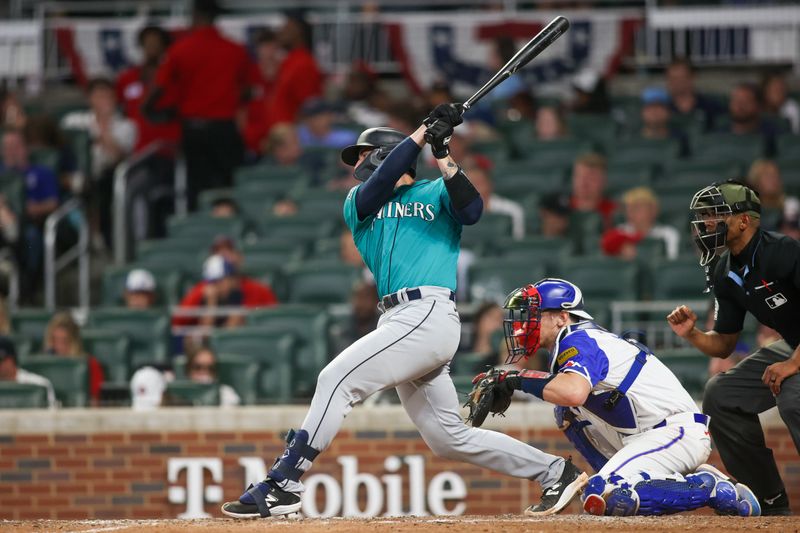 May 20, 2023; Atlanta, Georgia, USA; Seattle Mariners catcher Tom Murphy (2) hits a single against the Atlanta Braves in the seventh inning at Truist Park. Mandatory Credit: Brett Davis-USA TODAY Sports