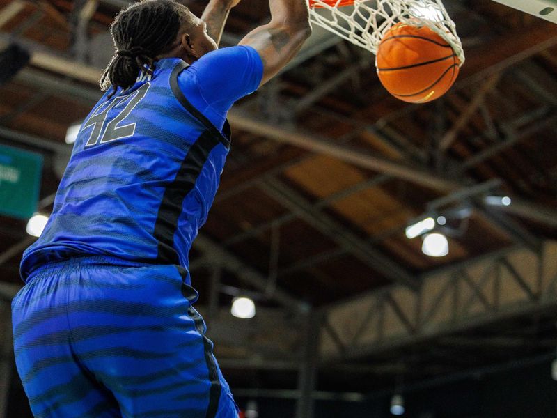 Jan 30, 2025; New Orleans, Louisiana, USA;  Memphis Tigers forward Dain Dainja (42) dunks the ball against the Tulane Green Wave during the first half at Avron B. Fogelman Arena in Devlin Fieldhouse. Mandatory Credit: Stephen Lew-Imagn Images