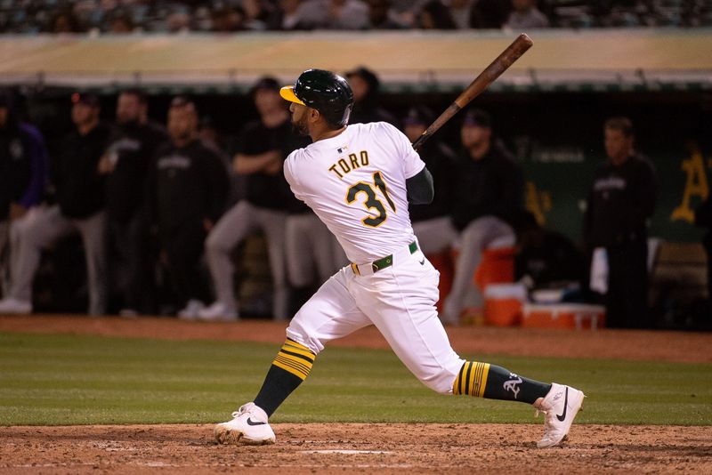 May 21, 2024; Oakland, California, USA; Oakland Athletics second base Abraham Toro (31) hits a home run against the Colorado Rockies during the eighth inning at Oakland-Alameda County Coliseum. Mandatory Credit: Ed Szczepanski-USA TODAY Sports