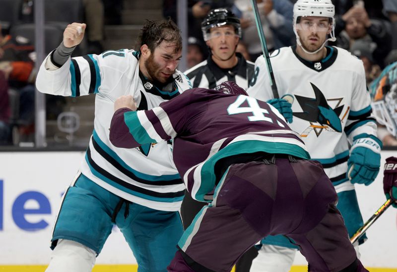 Nov 12, 2023; Anaheim, California, USA; San Jose Sharks center Luke Kunin (11) and Anaheim Ducks left wing Max Jones (49) fight during the second period at Honda Center. Mandatory Credit: Jason Parkhurst-USA TODAY Sports