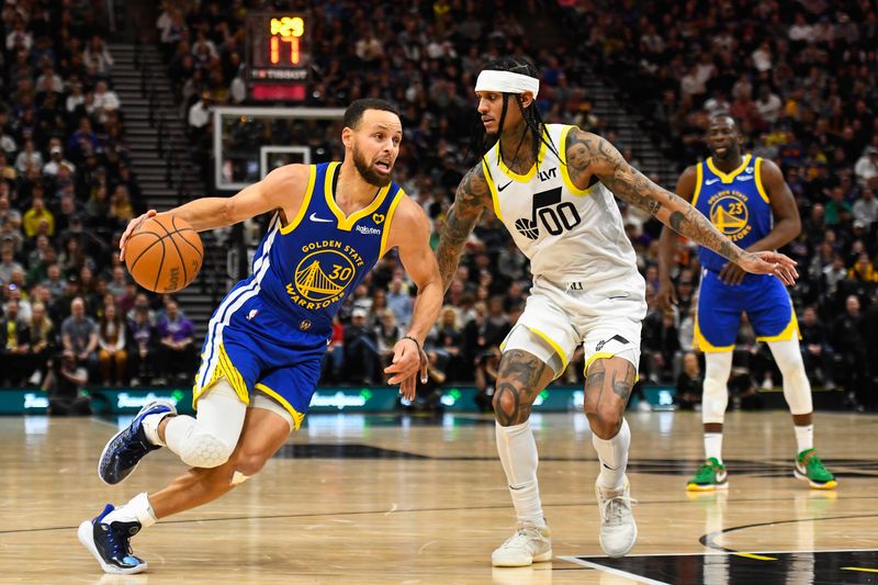 SALT LAKE CITY, UTAH - FEBRUARY 15: Stephen Curry #30 of the Golden State Warriors drives into Jordan Clarkson #00 of the Utah Jazz during the first half of a game at Delta Center on February 15, 2024 in Salt Lake City, Utah. NOTE TO USER: User expressly acknowledges and agrees that, by downloading and or using this photograph, User is consenting to the terms and conditions of the Getty Images License Agreement. (Photo by Alex Goodlett/Getty Images)