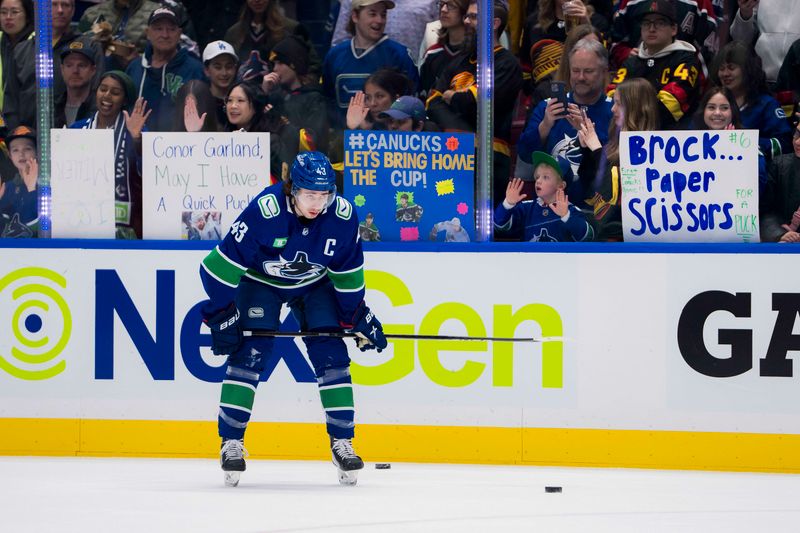 Mar 13, 2024; Vancouver, British Columbia, CAN; Vancouver Canucks defenseman Quinn Hughes (43) rests in front of fans during warm up prior to a game against the Colorado Avalanche at Rogers Arena. Mandatory Credit: Bob Frid-USA TODAY Sports