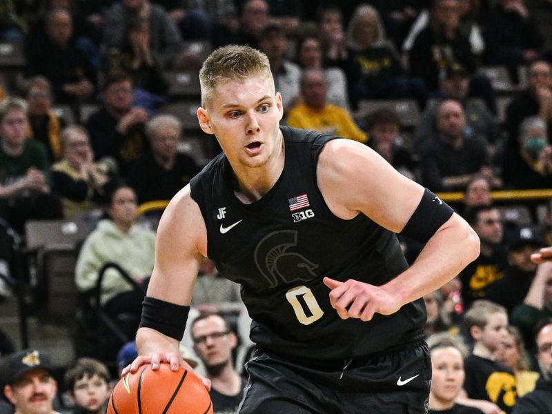 Mar 6, 2025; Iowa City, Iowa, USA; Michigan State Spartans forward Jaxon Kohler (0) controls the ball during the first half against the Iowa Hawkeyes at Carver-Hawkeye Arena. Mandatory Credit: Jeffrey Becker-Imagn Images