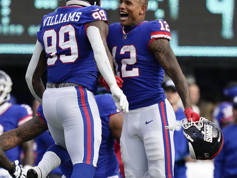 New York Giants defensive end Leonard Williams (99) celebrates with tight end Darren Waller (12) after blocking a field goal attempt by the Washington Commanders during the fourth quarter of an NFL football game, Sunday, Oct. 22, 2023, in East Rutherford, N.J. (AP Photo/Seth Wenig)