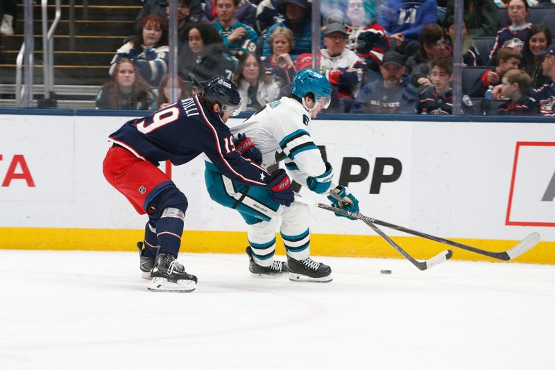 Mar 28, 2026; Columbus, Ohio, USA; San Jose Sharks defenseman Sam Dickinson (6) and Columbus Blue Jackets center Adam Fantilli (19) battle for a loose puck during the first period at Nationwide Arena. Mandatory Credit: Russell LaBounty-Imagn Images