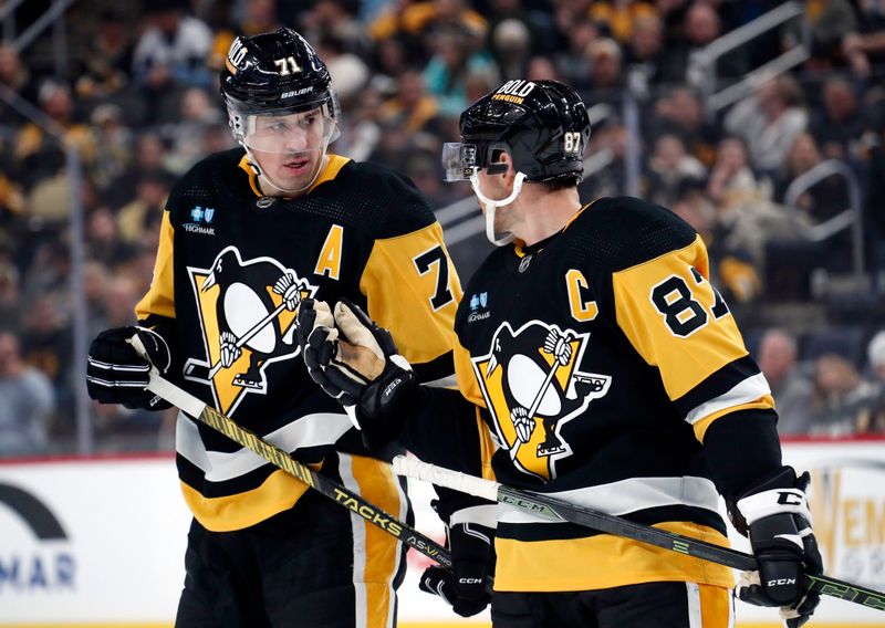 Oct 28, 2023; Pittsburgh, Pennsylvania, USA; Pittsburgh Penguins center Evgeni Malkin (71) listens to center Sidney Crosby (87) prior to a face-off against the Ottawa Senators during the first period at PPG Paints Arena. Mandatory Credit: Charles LeClaire-USA TODAY Sports