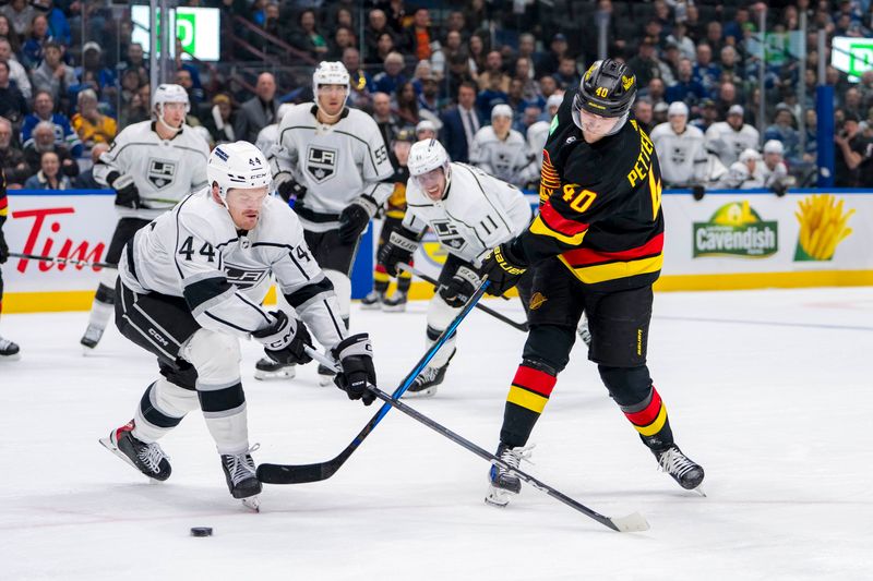 Mar 25, 2024; Vancouver, British Columbia, CAN; Vancouver Canucks forward Elias Pettersson (40) shoots around Los Angeles Kings defenseman Mikey Anderson (44) in the third period at Rogers Arena. Kings won 3 -2. Mandatory Credit: Bob Frid-USA TODAY Sports