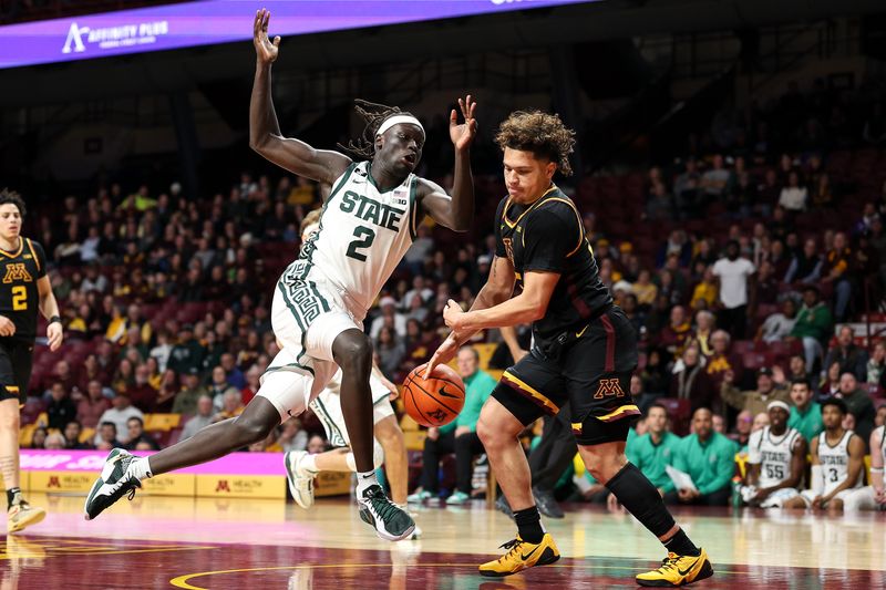 Dec 4, 2024; Minneapolis, Minnesota, USA; Michigan State Spartans guard Kur Teng (2) drives towards the basket as Minnesota Golden Gophers guard Lu'Cye Patterson (25) defends during the second half at Williams Arena. Mandatory Credit: Matt Krohn-Imagn Images