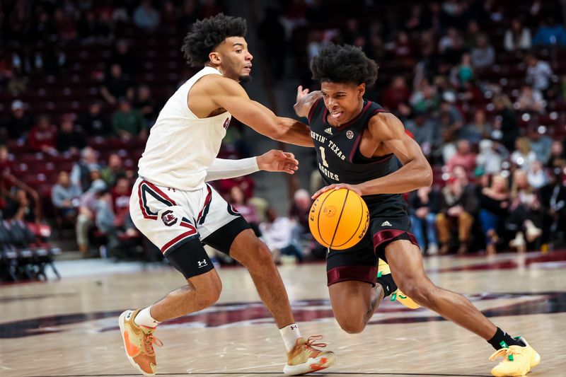 Jan 14, 2023; Columbia, South Carolina, USA; Texas A&M Aggies guard Khalen Robinson (1) drives past South Carolina Gamecocks guard Jacobi Wright (1) in the second half at Colonial Life Arena. Mandatory Credit: Jeff Blake-USA TODAY Sports