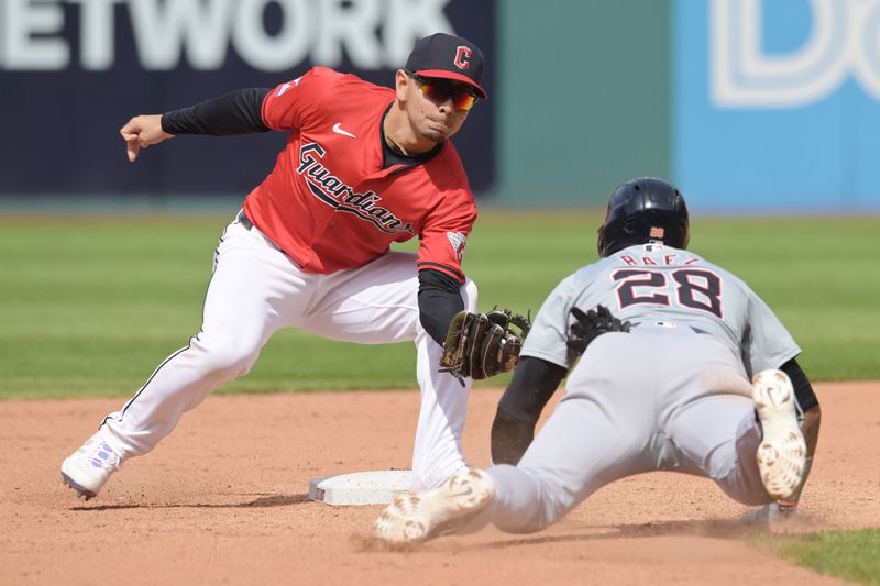 May 8, 2024; Cleveland, Ohio, USA; Cleveland Guardians second baseman Andres Gimenez (0) tags out Detroit Tigers shortstop Javier Baez (28) during the tenth inning at Progressive Field. Mandatory Credit: Ken Blaze-USA TODAY Sports