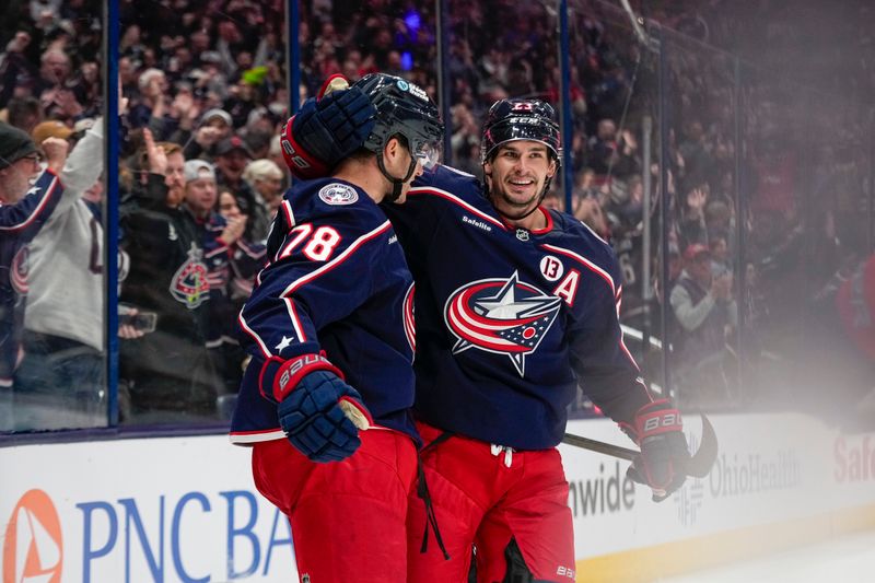 Oct 17, 2024; Columbus, Ohio, USA; Columbus Blue Jackets defenseman Damon Severson (78) celebrates with center Sean Monahan (23) after Severson scored a goal in the third period at Nationwide Arena on Thursday. Mandatory Credit: Samantha Madar/USA TODAY Network via Imagn Images