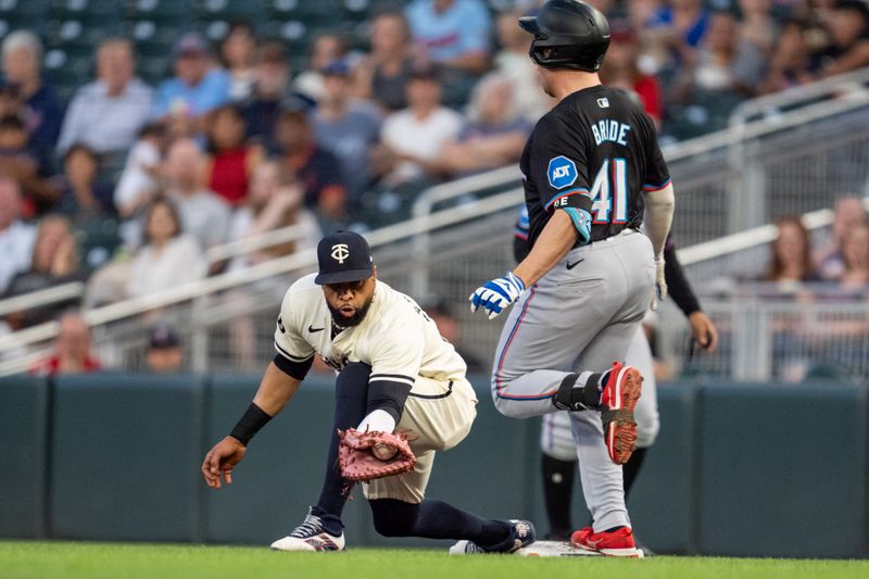 Sep 26, 2024; Minneapolis, Minnesota, USA; Miami Marlins first base Jonah Bride (41) is safe at first as Minnesota Twins first base Carlos Santana (30) catches the throw from second base Willi Castro (50) at Target Field. Mandatory Credit: Matt Blewett-Imagn Images