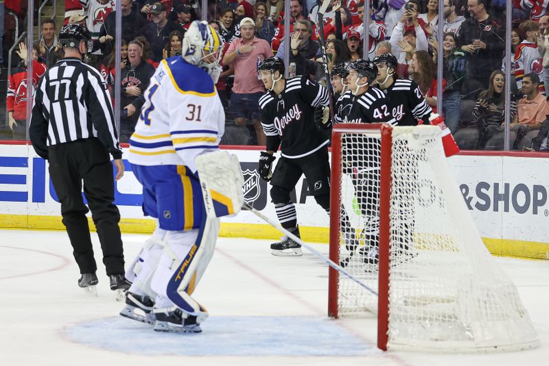 Oct 27, 2023; Newark, New Jersey, USA; New Jersey Devils right wing Alexander Holtz (10) celebrates his goal against Buffalo Sabres goaltender Eric Comrie (31) with teammates during the first period at Prudential Center. Mandatory Credit: Vincent Carchietta-USA TODAY Sports