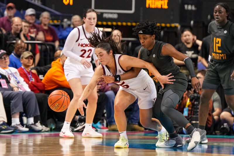 Mar 8, 2024; Greensboro, NC, USA; A Miami Hurricanes defender knocks the ball away from Virginia Tech Hokies guard Georgia Amoore (5) in the second half at Greensboro Coliseum. Mandatory Credit: David Yeazell-USA TODAY Sports