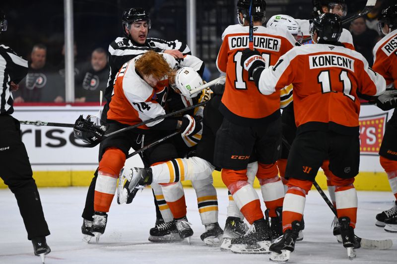 Nov 2, 2024; Philadelphia, Pennsylvania, USA; Philadelphia Flyers right wing Owen Tippett (74) and Boston Bruins center Matthew Poitras (51) fight in the third period at Wells Fargo Center. Mandatory Credit: Kyle Ross-Imagn Images