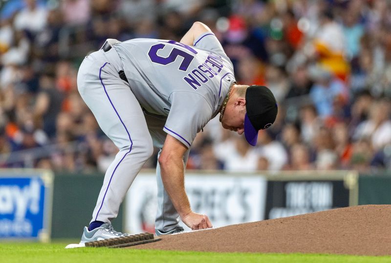 Jul 5, 2023; Houston, Texas, USA; Colorado Rockies starting pitcher Chase Anderson (45) writes on the mound before pitching against the Houston Astros in the first inning at Minute Maid Park. Mandatory Credit: Thomas Shea-USA TODAY Sports