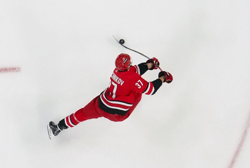 Dec 23, 2023; Raleigh, North Carolina, USA; Carolina Hurricanes right wing Andrei Svechnikov (37) takes a shot against the New York Islanders during the second period at PNC Arena. Mandatory Credit: James Guillory-USA TODAY Sports