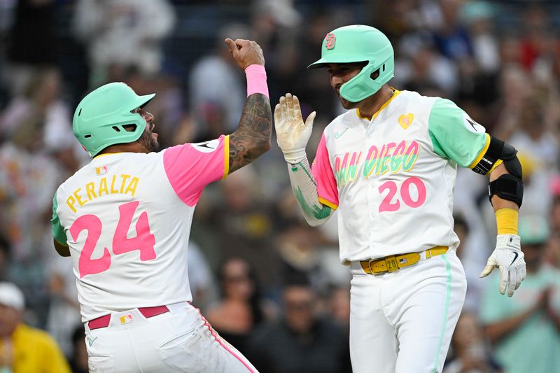 Aug 23, 2024; San Diego, California, USA; San Diego Padres catcher Kyle Higashioka (20) is congratulated by  David Peralta (24) after hitting a two-run home run during the second inning against the New York Mets at Petco Park. Mandatory Credit: Denis Poroy-USA TODAY Sports