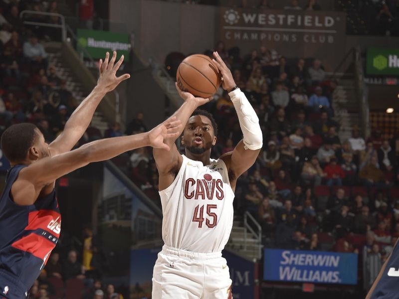 CLEVELAND, OH - DECEMBER 13: Donovan Mitchell #45 of the Cleveland Cavaliers shoots a three point basket during the game against the Washington Wizards on December 13, 2024 at Rocket Mortgage FieldHouse in Cleveland, Ohio. NOTE TO USER: User expressly acknowledges and agrees that, by downloading and/or using this Photograph, user is consenting to the terms and conditions of the Getty Images License Agreement. Mandatory Copyright Notice: Copyright 2024 NBAE (Photo by David Liam Kyle/NBAE via Getty Images)