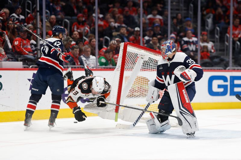 Jan 16, 2024; Washington, District of Columbia, USA; Washington Capitals defenseman Martin Fehervary (42) checks Anaheim Ducks center Mason McTavish (23) into the goal of Capitals goaltender Darcy Kuemper (35) in the second period at Capital One Arena. Mandatory Credit: Geoff Burke-USA TODAY Sports