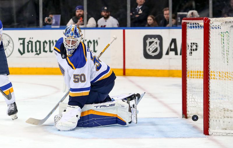 Mar 9, 2024; New York, New York, USA; St. Louis Blues goalie Jordan Binnington (50) tries to stop a shot by New York Rangers center Matt Rempe (73) which was at first called a goal but then overruled after replay during the second period at Madison Square Garden. Mandatory Credit: Danny Wild-USA TODAY Sports