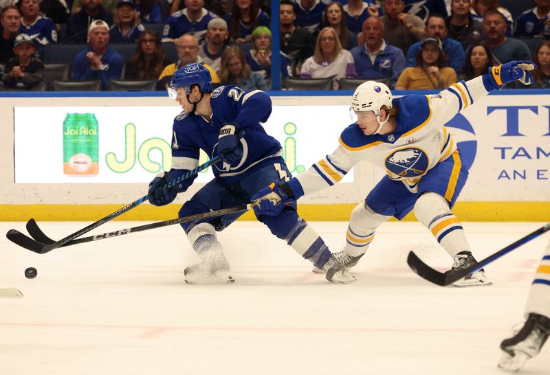 Apr 15, 2024; Tampa, Florida, USA;  Buffalo Sabres defenseman Bowen Byram (4) defends Tampa Bay Lightning center Brayden Point (21) during the first period at Amalie Arena. Mandatory Credit: Kim Klement Neitzel-USA TODAY Sports