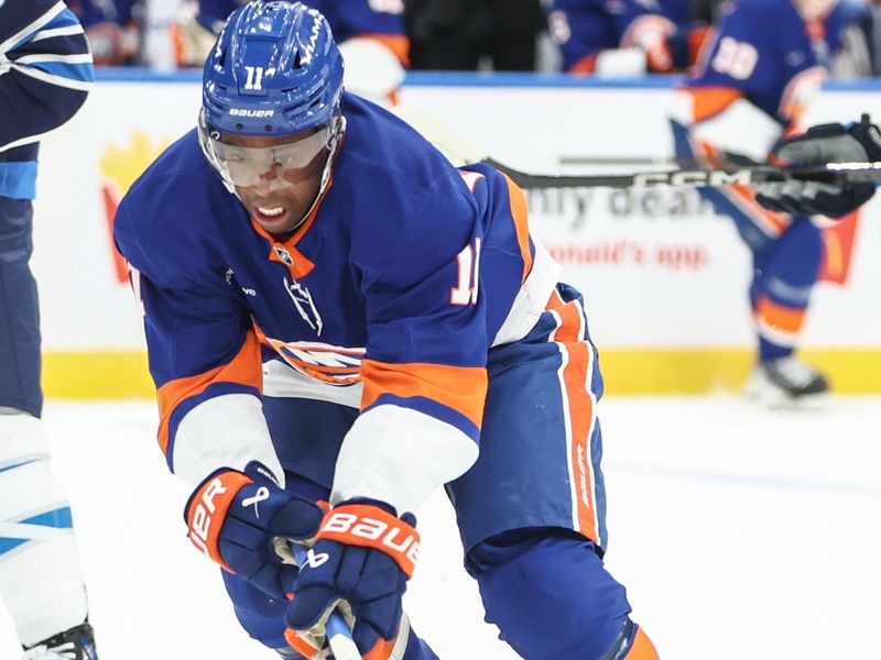 Mar 4, 2025; Elmont, New York, USA;  New York Islanders left wing Anthony Duclair (11) controls the puck in the second period against the Winnipeg Jets at UBS Arena. Mandatory Credit: Wendell Cruz-Imagn Images